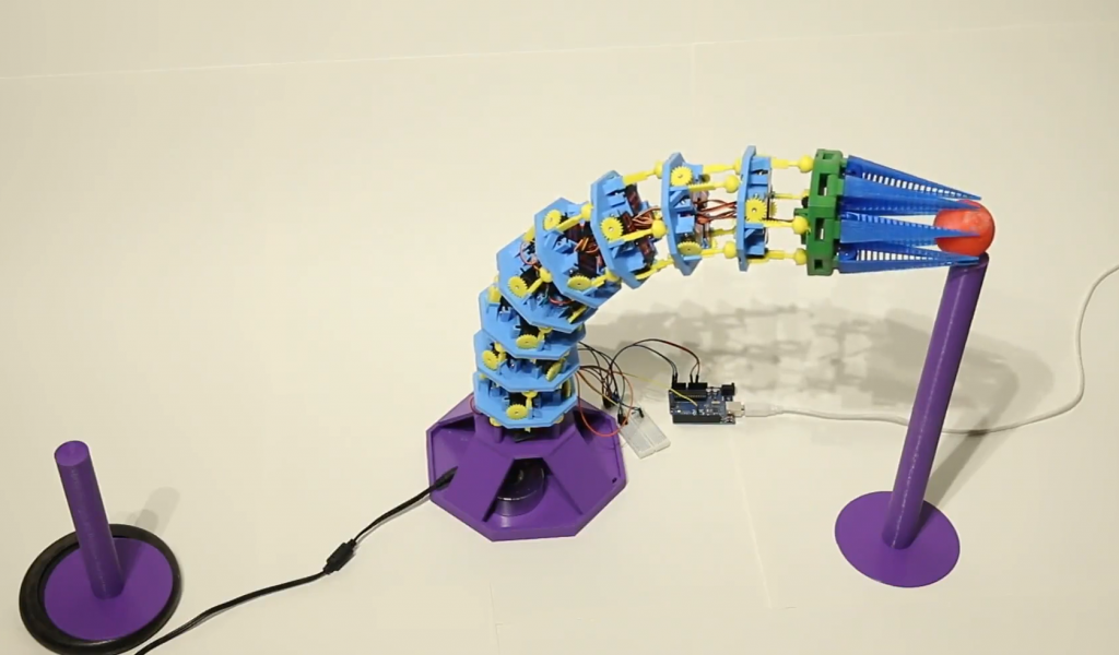The robot learning to pick up and place marbles. Photo via University of Tübingen.