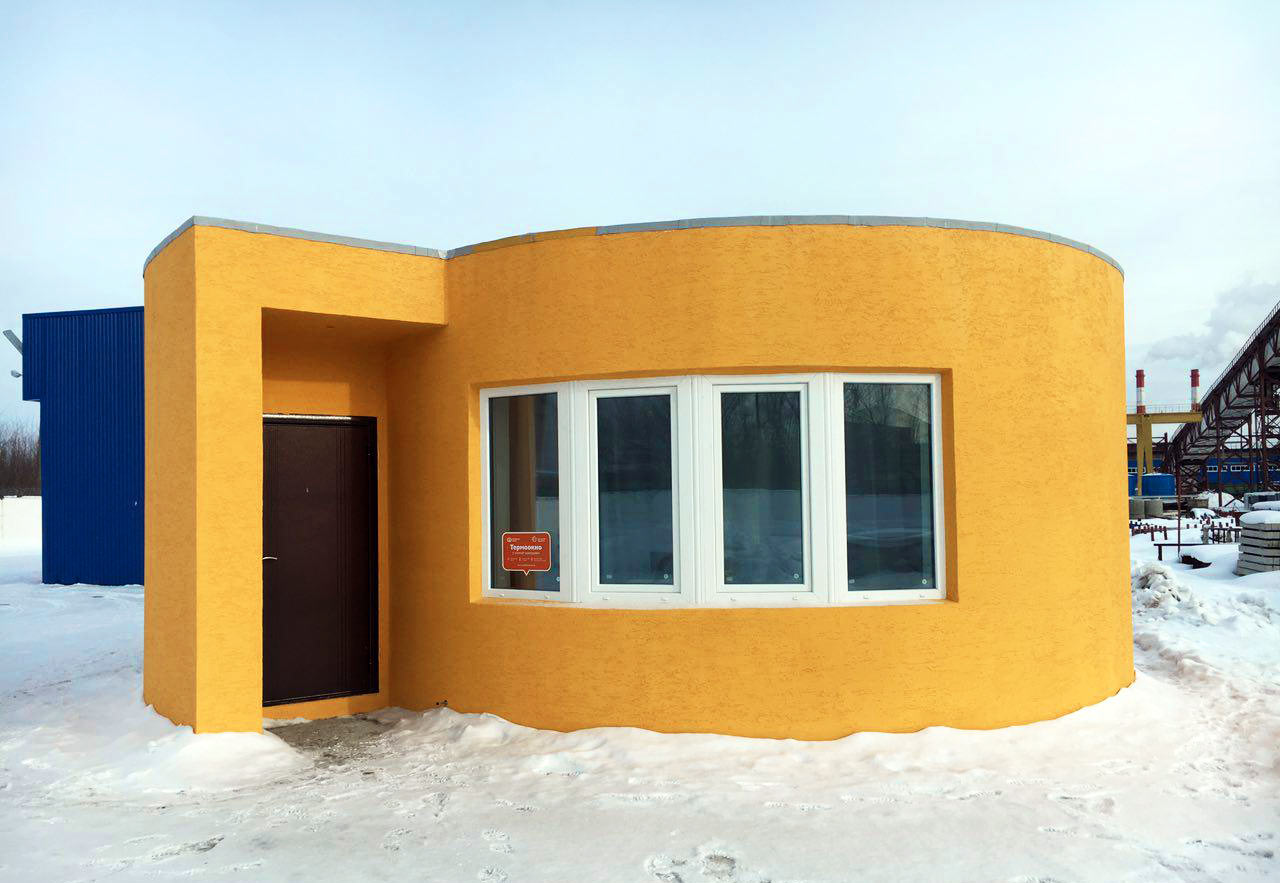 The external of the 3D printed house. Photo via Apis Cor.