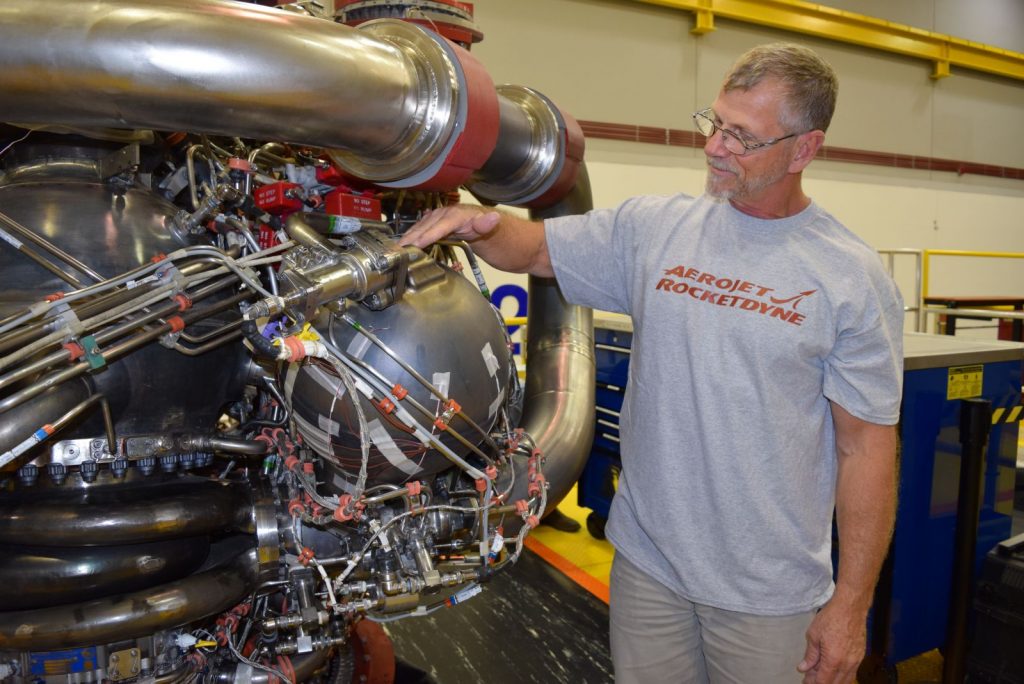 An Aerojet Rocketdyne technician inspects the 3D printed pogo accumulator assembly on an RS-25 development engine. Photo via Aerojet Rocketdyne