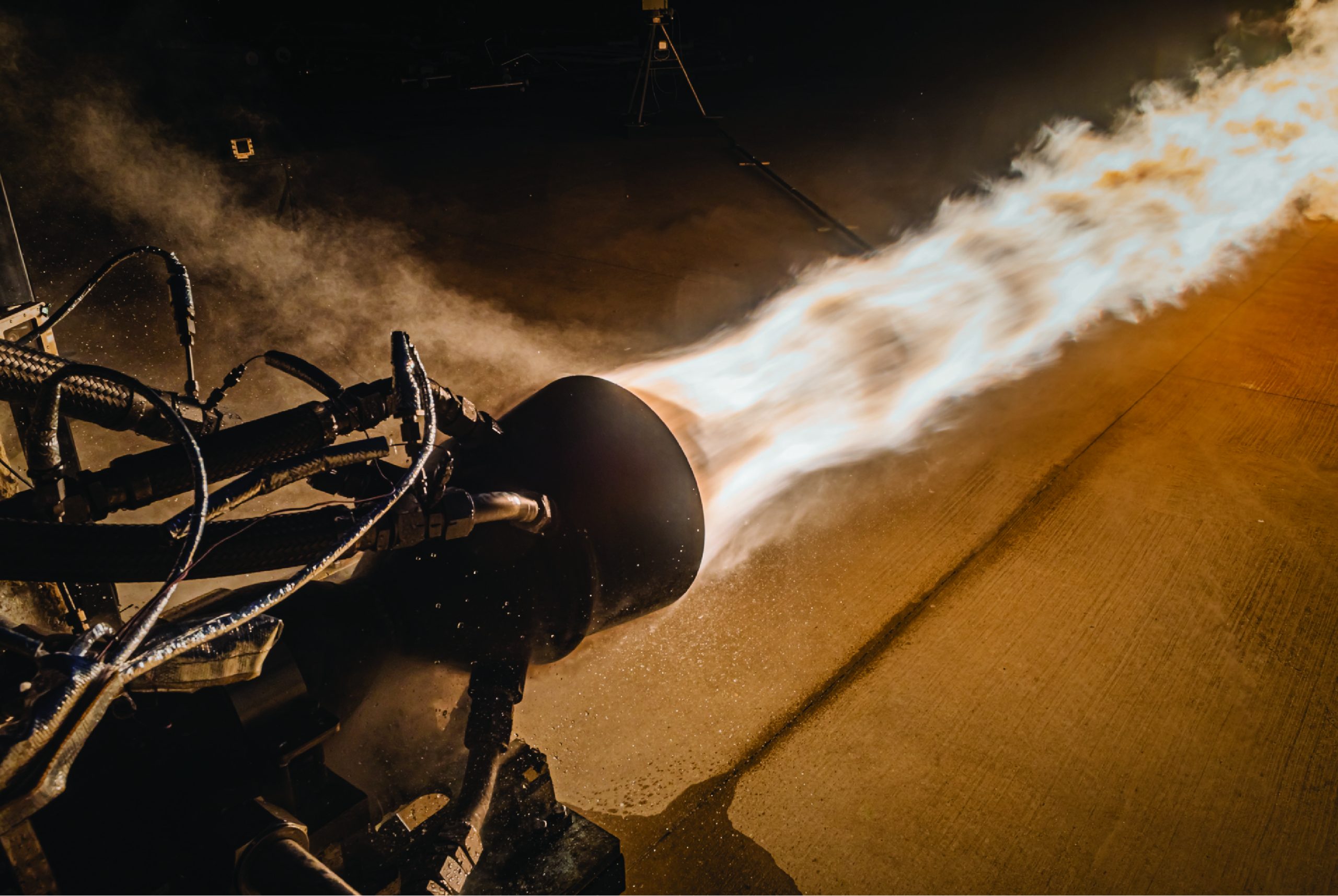 Launcher conducts a hot fire test for its 3D-printed Engine-2 rocket engine in the E Test Complex at NASA’s Stennis Space Center. Photo via Launcher/John Kraus Photography.